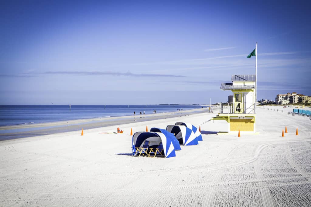 White sand beach with cabanas and a life guard stand