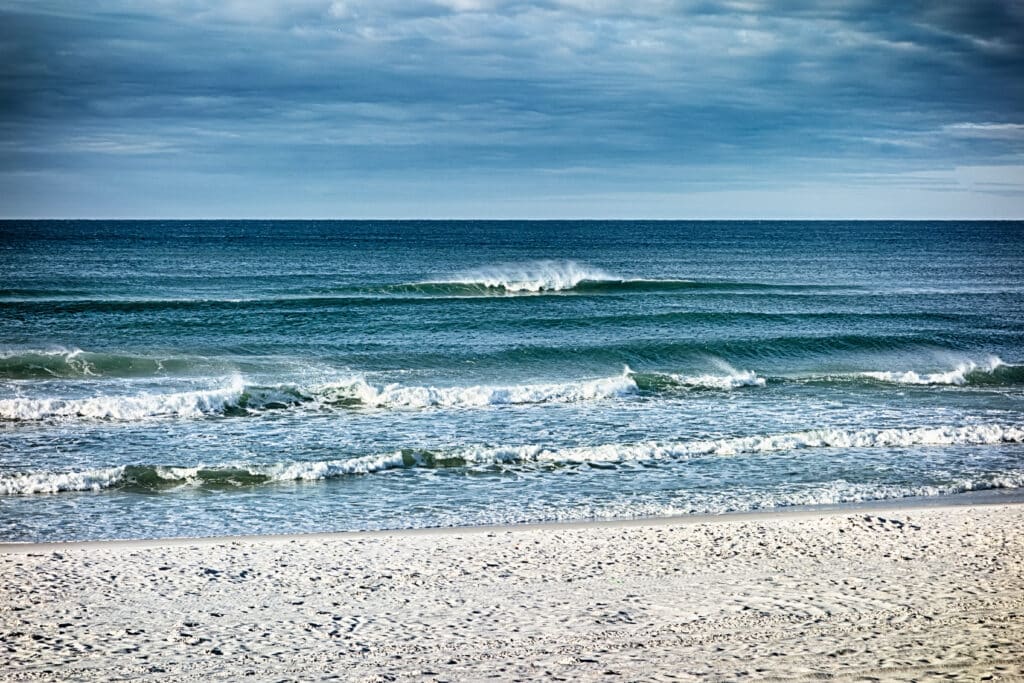 waves breaking on a sandy shell beach